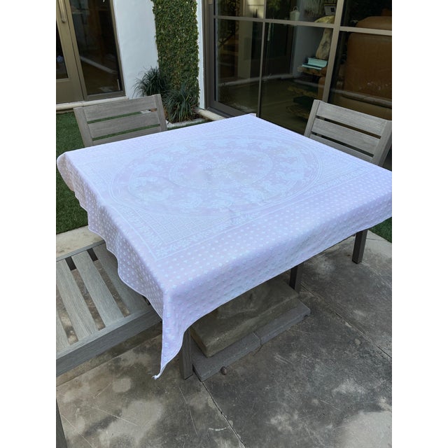 This is a medium weight woven cotton square tablecloth with a pretty design of ducks walking in a circle round the middle...