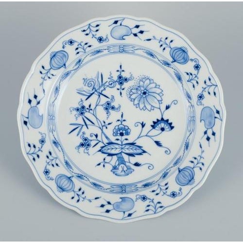 Meissen, Germany. A set of four Blue Onion Pattern dinner plates in porcelain. Hand-painted. First half of the 20th...