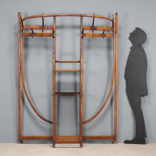 Thonet wall-mounted coat rack in bent beech, stained walnut. Eight coat hooks on top, five umbrella stands in the lower...