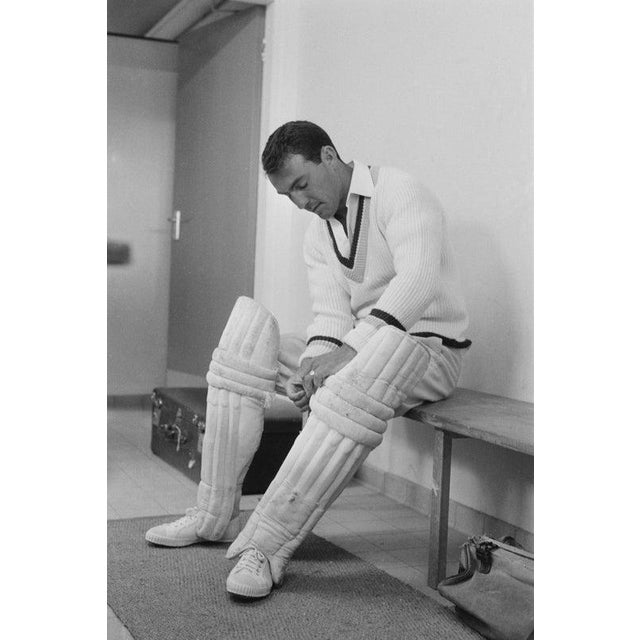 Jimmy Greaves English soccer player Jimmy Greaves wearing cricket uniform in a locker room before taking part in a...
