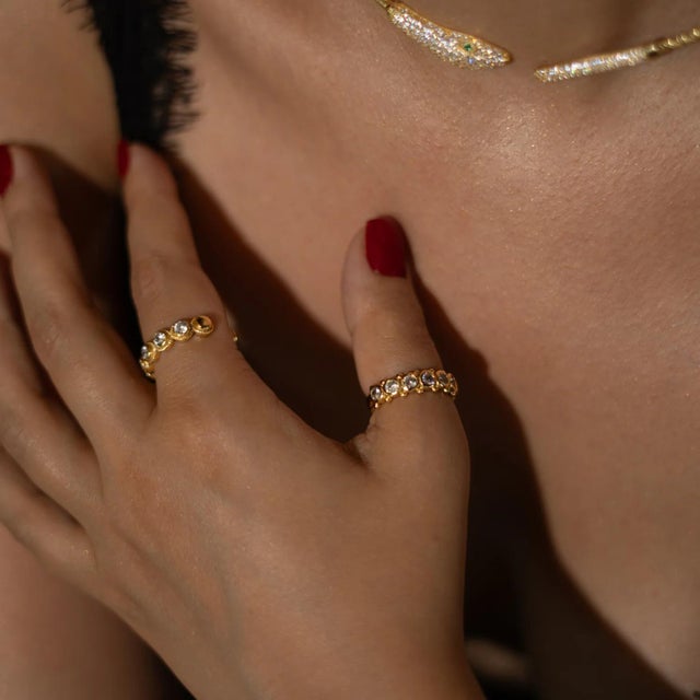 Shine with brilliance in the Majestic CZ Diamond Adjustable Gold Statement Ring. A sparkling CZ diamond centerpiece...