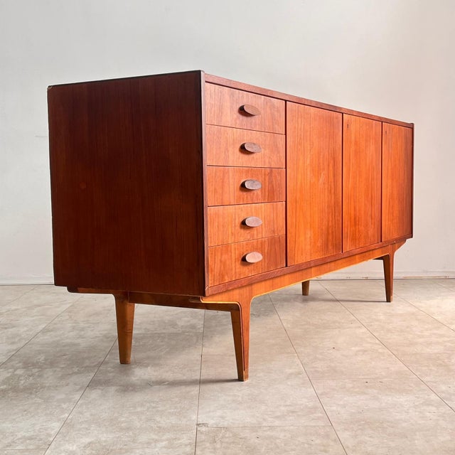 A refined example of mid-century Italian design, this sideboard embodies the functional elegance of the 1960s. Crafted...