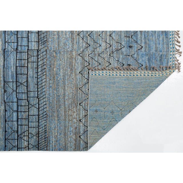 This stunning hand-woven wool rug blends traditional Moroccan craftsmanship with a sophisticated, modern aesthetic....