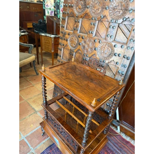 The Antique English Walnut Magazine Rack (Canterbury) is a beautifully crafted handmade piece made of wood, featuring a...