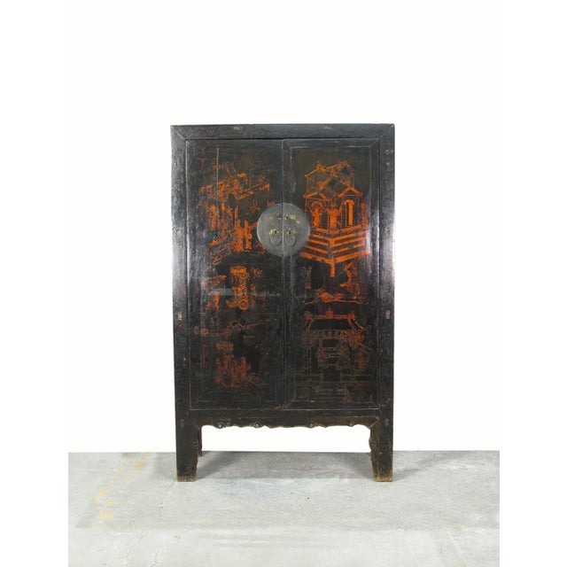 The two panels door of this black Chinese Chinoiserie cabinet is adorn with hand painted figural performing in the court...