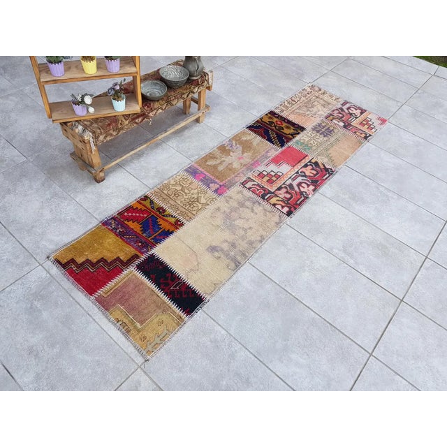 This is a vintage Turkish Oushak rug from the Mid 20th Century. The piece was hand-knotted.