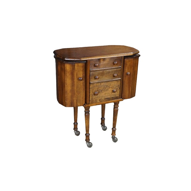 Antique Martha Washington walnut sewing cabinet. Features a distinctive octagonal top with clipped corners over a three-...