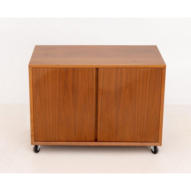 Danish Modern Teak Cabinet, with two doors opening to two shelves atop casters. 23" H x 31.5" W x 18.25" D. Provenance:...