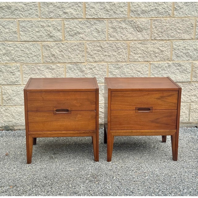 Mid-century modern nightstands featuring two spacious drawers and a warm walnut finish.