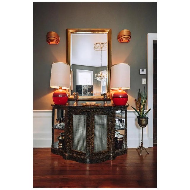 Vintage 1970s Hollywood Regency oversized brass wall mirror featuring a beveled glass edge and substantial brass frame....
