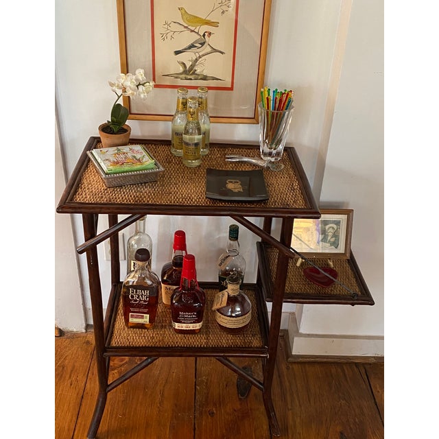 Charming two-tier table that works well as a dry bar or side table. One side folds down to save space as needed.