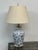 Design Plus Gallery presents a Blue + White Porcelain Table Lamp with Asian Influence. The white lamp has foliage in blue...