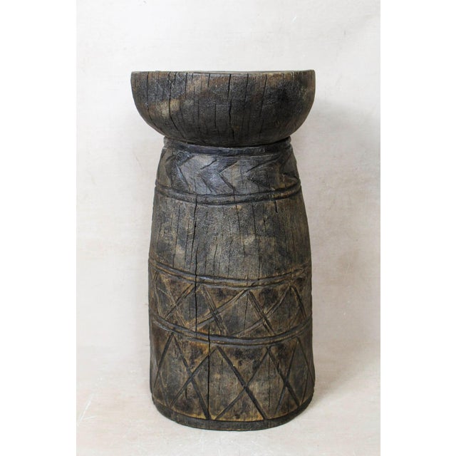 African grain stompers are made when they hollow out tree trucks and large branches to create these which are then used to...