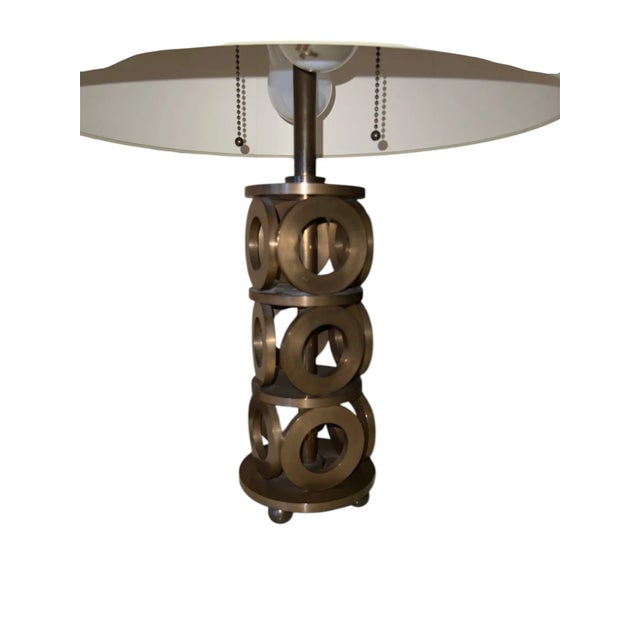 This beautiful American modernist table lamp Circa 1900's, machine-age, with circling forming its base is kept in great...