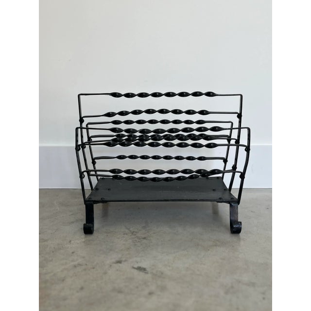 Charming French mag rack made up of wrought iron curls from the feet to the top. A great addition to corral your magazines...