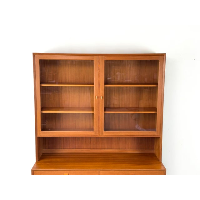 High-quality, two-part display cabinet from Denmark. The base cabinet has six drawers, topped by a hutch with two lockable...