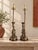 A distinctive pair of decorative elephant table lamps featuring intricately detailed elephant figures with raised trunks,...