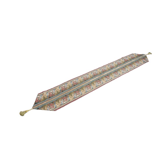 This traditional woven tapestry table runner features an elegant, symmetrical botanical design styled after classic...