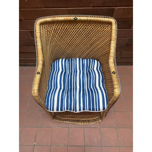 This unique charming 1970s vintage coastal wicker chair is a beautiful addition to any room. The chair features a cushion...