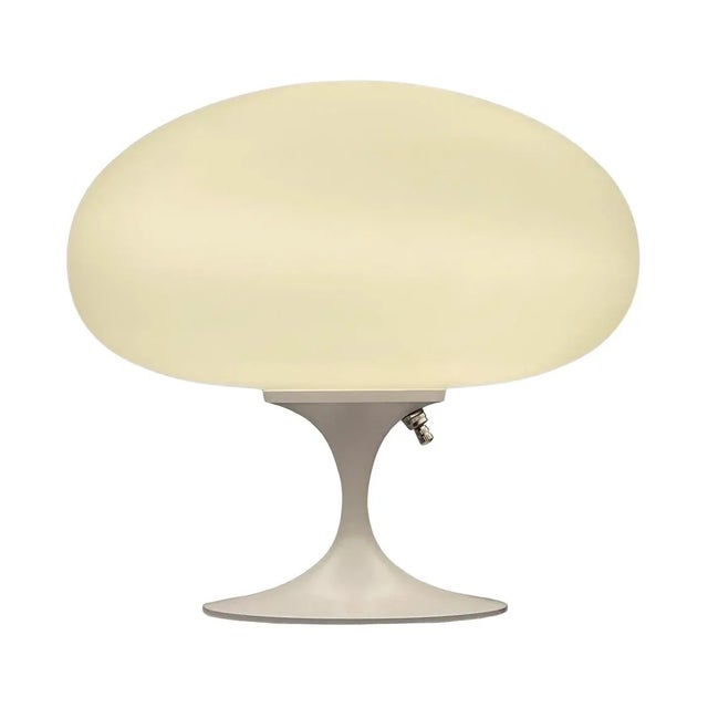 A gorgeous tulip form table lamp after Laurel Lamp Company. The lamp features a green lacquered cast aluminum base with a...