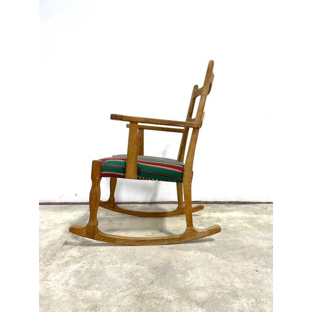 Rocking chair in solid oak. Original upholstery. Designed by Henning Kjærnulf for E.G Møbelfabrik. Denmark 1960s.