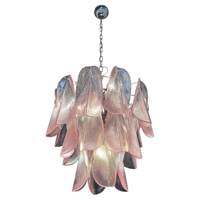 Italian vintage murano chandelier. The fixture is made up of 23 individual handblown pink glass elements hanging from a...