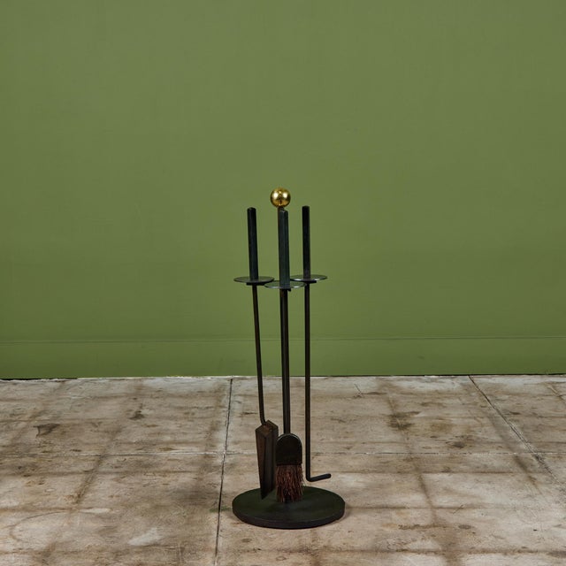 Fireplace tool set designed by Mel Bogart for Felmore, USA, c.1950s. The set features three wrought iron fireplace tools...