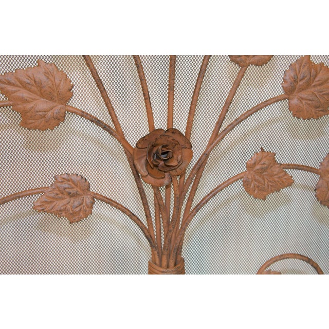 3-panel fireplace screen detailed with the silhouette of a bouquet of vines of rose flower. Subtle muted red-brown color....