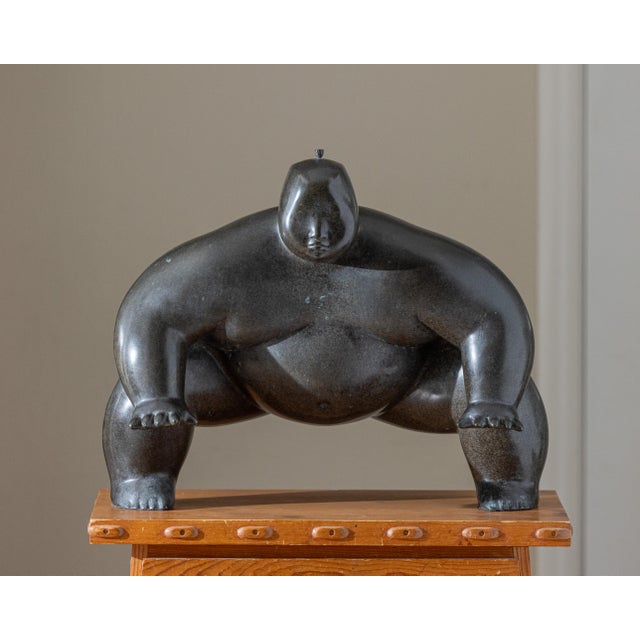 A monumental cast bronze figurative sculpture depicting a crouching sumo wrestler, signed and dated "YURI 05." Beautifully...