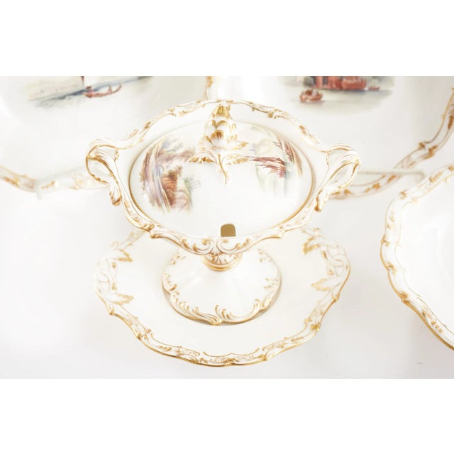 19th Century English hand painted porcelain dessert / luncheon service with gilt gold and painted interior scene details....