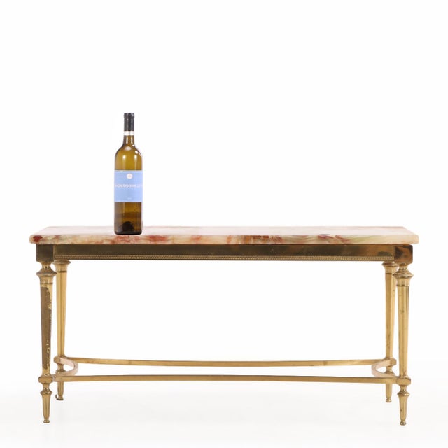 The richly figured cream onyx top, beautifully veined with tones of gold, pale green, and soft pink, rests within a...