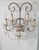 A pair of semi antique wall sconces in the manner of Maison Baguès. Each sconce has five candle style lightbulb holders...