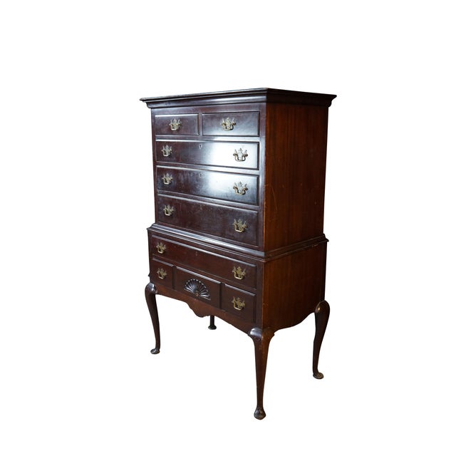 This is a vintage Queen Anne style two-piece mahogany highboy chest manufactured by the Kaplan Furniture Company of...