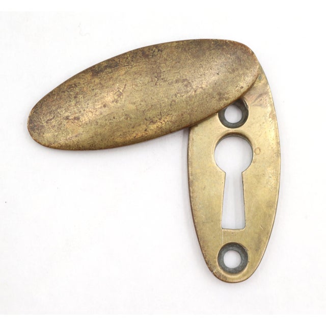 Classic oval shaped brass keyhole with draft cover. The original mounting screws are not available. Good condition with...