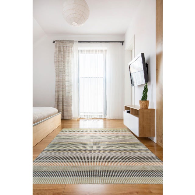 Louie Ophelia Beige Handmade Wool Rug, Country of Origin: India. This striking contemporary piece showcases the...