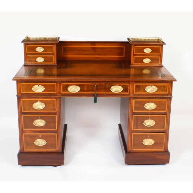 This is a superb antique late victorian flame mahogany string inlaid and satinwood crossbanded pedestal kneehole desk,...