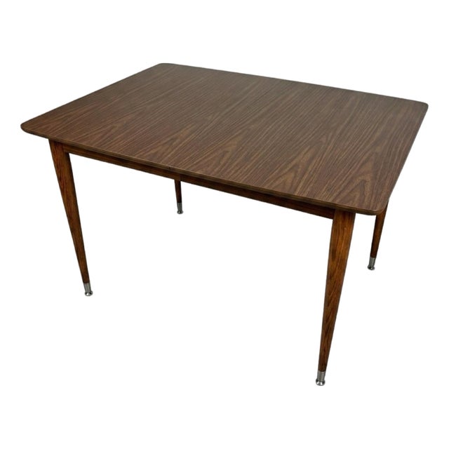 Vintage Mid-Century Modern Wood and Formica Dining Table Featuring Tapered Legs With Metal Tips. For Sale