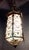 C. 1920's Spanish Revival hexagonal form hanging lantern having decorative metal frame. Shade is ornamented with scrolling...
