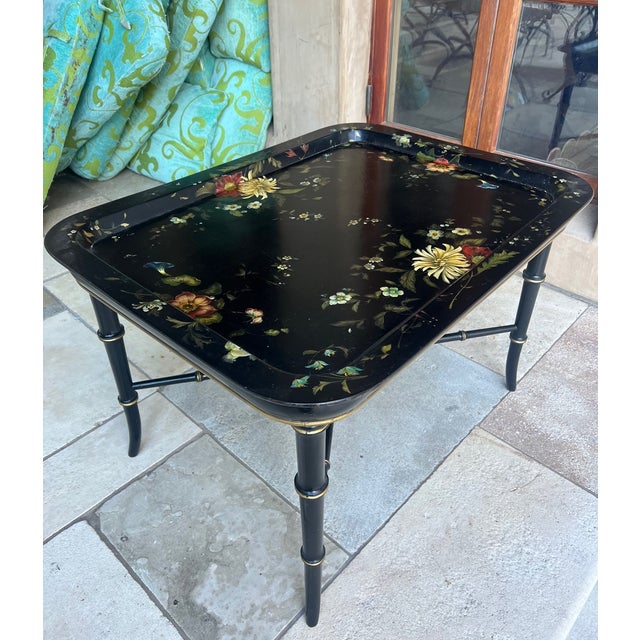 19th Century English Victorian black lacquered tray table. The tray hand painted with flowers can be removed.