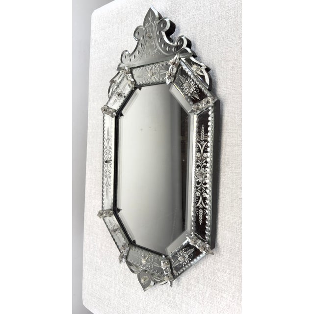 A gorgeous semi-antique Venetian glass octagonal mirror with elaborately detailed frame circa 1950’s. Features beveled...