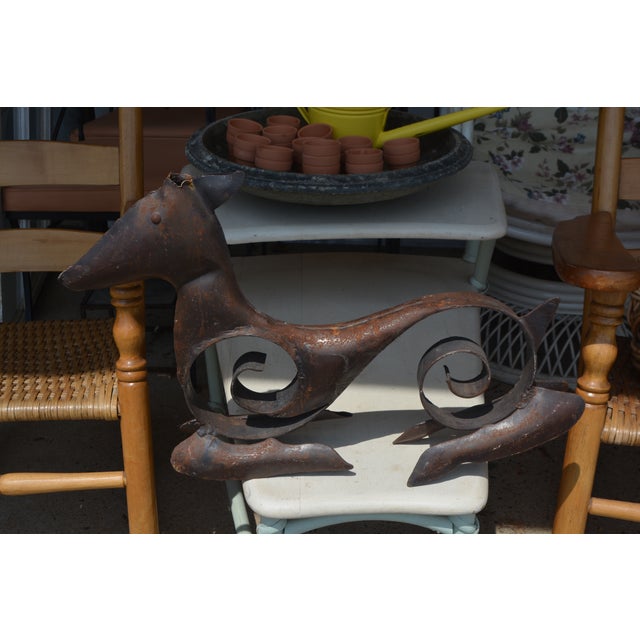 This neat looking deer sculpture appears to be hand made. Nothing written on it, no labels. It has a rustic/primitive look...