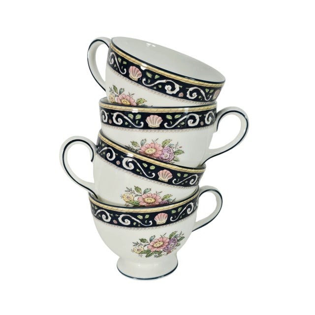 A refined display of English craftsmanship, these Wedgwood Runnymede tea cups embody classic floral elegance framed by...