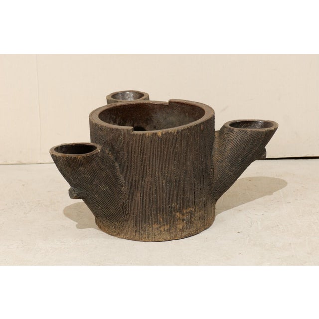 An American tree trunk shaped planter. This American planter from the mid 20th century features a rich brown, high fired...