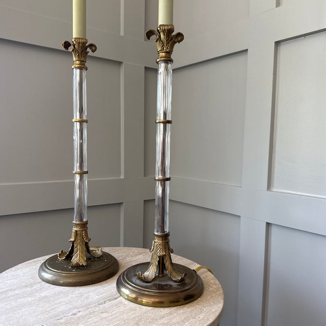 Set of 2. Design Motifs: The lamps feature detailed brass palm frond accents at the top and bottom of the column Column...