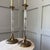 Set of 2. Design Motifs: The lamps feature detailed brass palm frond accents at the top and bottom of the column Column...