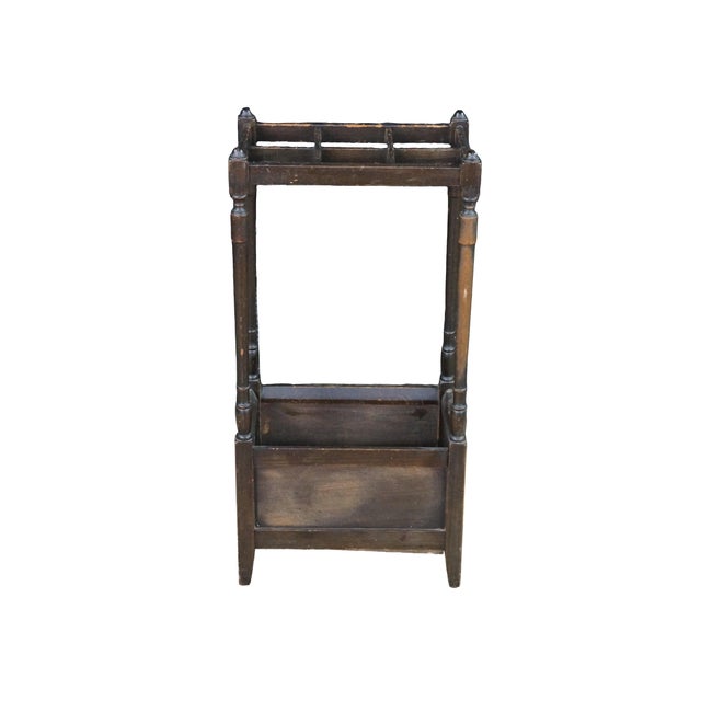 This antique umbrella and cane stand is crafted from solid mahogany with a dark, rich finish that accentuates the dense,...