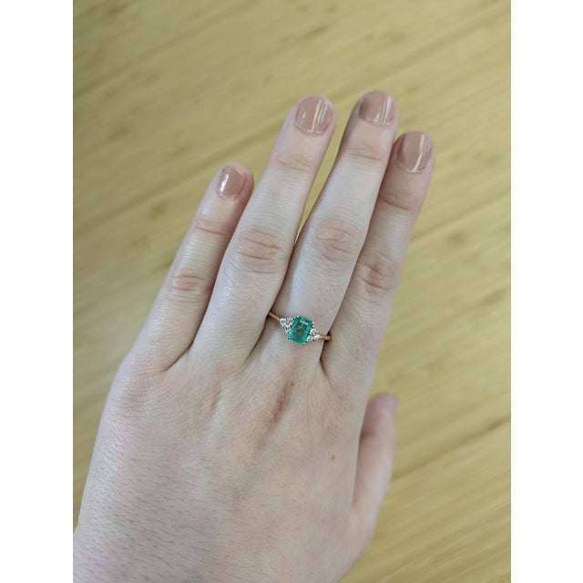 This Ethiopian emerald ring combines classic design with a bold twist. Set in 14K solid gold with natural diamond accents,...