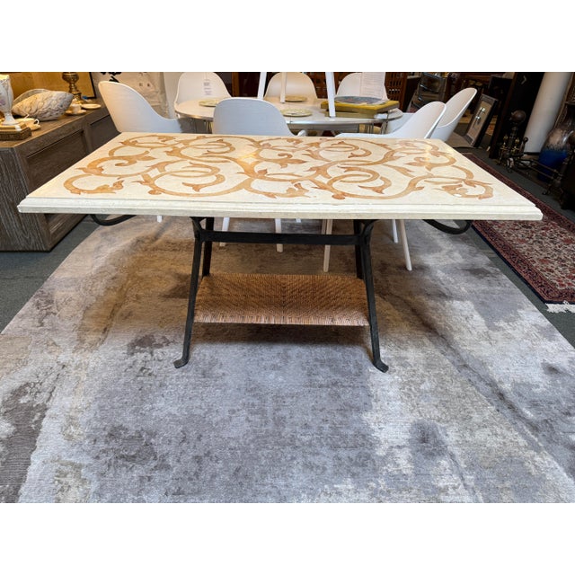 Design Plus Gallery presents an Indoor/Outdoor Dining Table with Marble Top and Wrought Iron Base. The table has a cream...