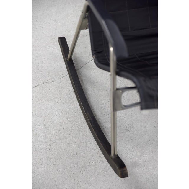 This folding modern rocking chair was designed by takeshi nii during the 1950s. It has a black leather upholstered and...