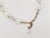 This is part of Chairish’s Costume Jewelry assortment. Early 1960s goldtone cut glass and white "moonglow" faux-moonstone...